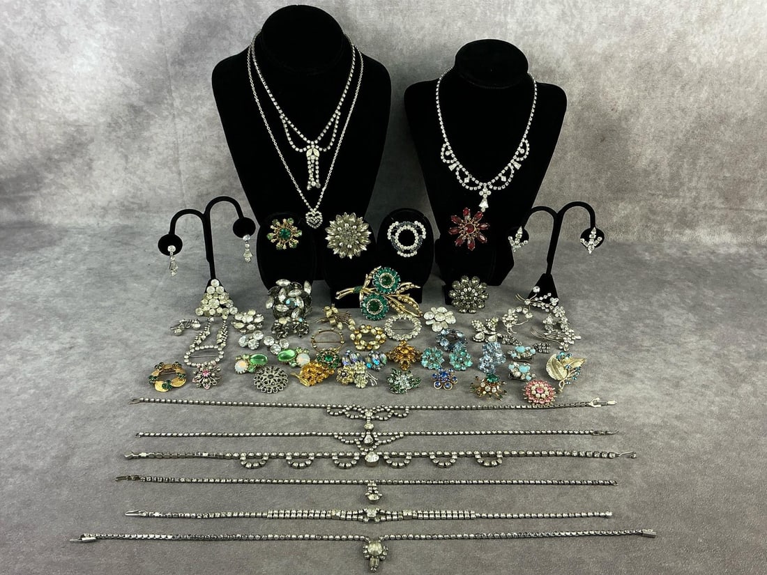 Costume Jewelry: Fifty four pieces of vintage costume jewelry including brooches, necklaces, and earrings. Brands include Weiss, Coro, and Karu. All in good condition. Largest measures 1.75 inches in diameter.