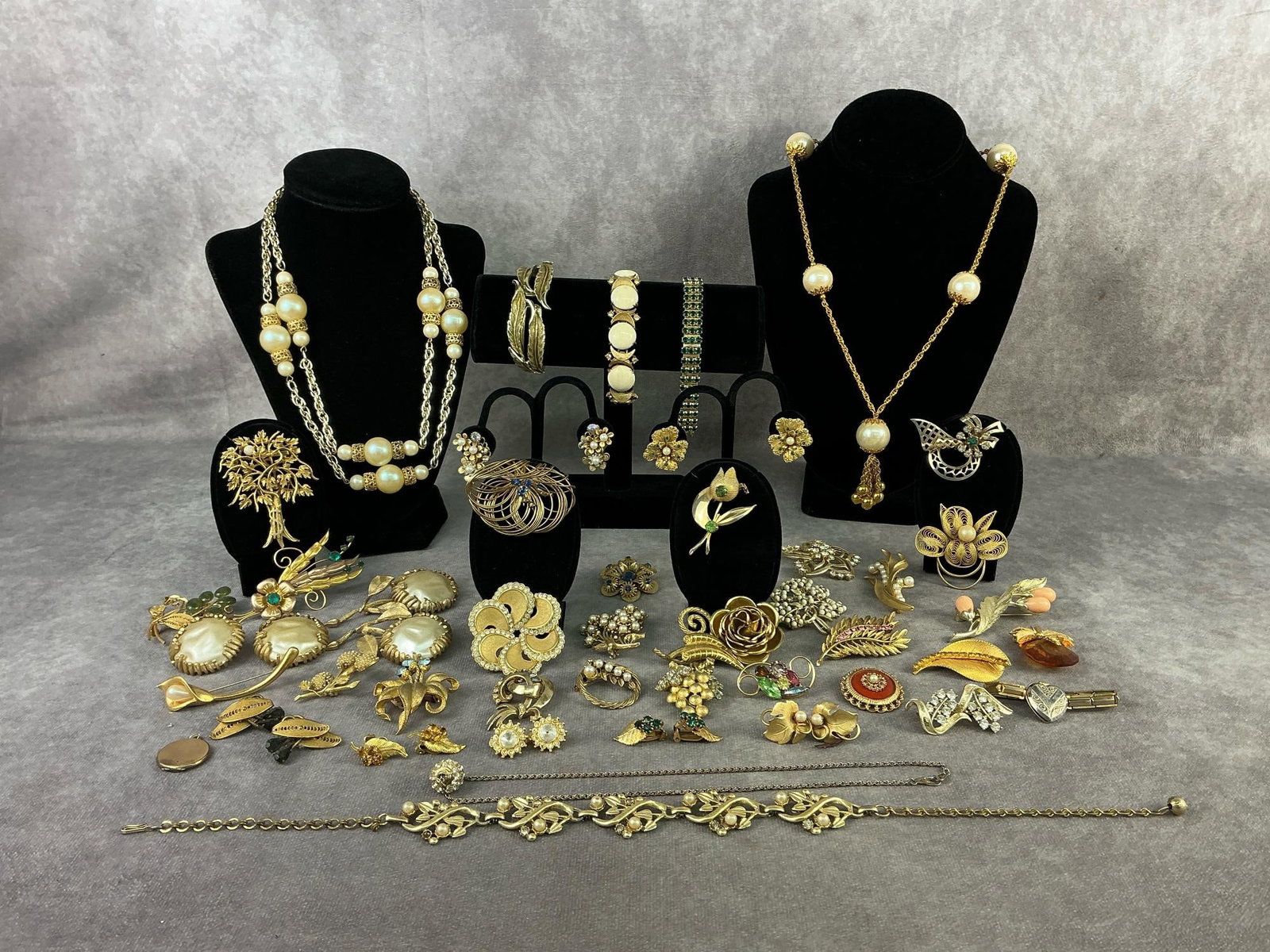 Costume Jewelry: Forty six pieces of vintage costume jewelry including necklaces, earrings, brooches, bracelets, and lockets. Brands are Sarah Coventry, Trifari, and Gerry's. One brooch has a broken pin back, others