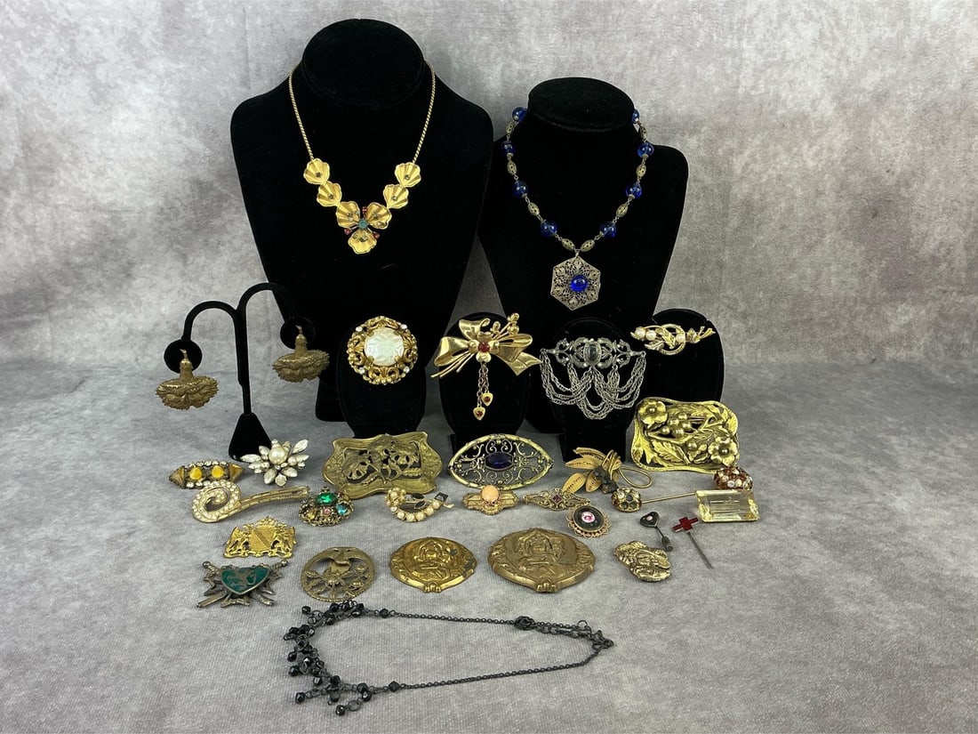 Costume Jewelry: Thirty pieces of antique and vintage costume jewelry including necklaces, brooches, earrings, and stick pins. Victorian pressed metal brooches and scarf clips, enamel stick pins and brooch, and more.