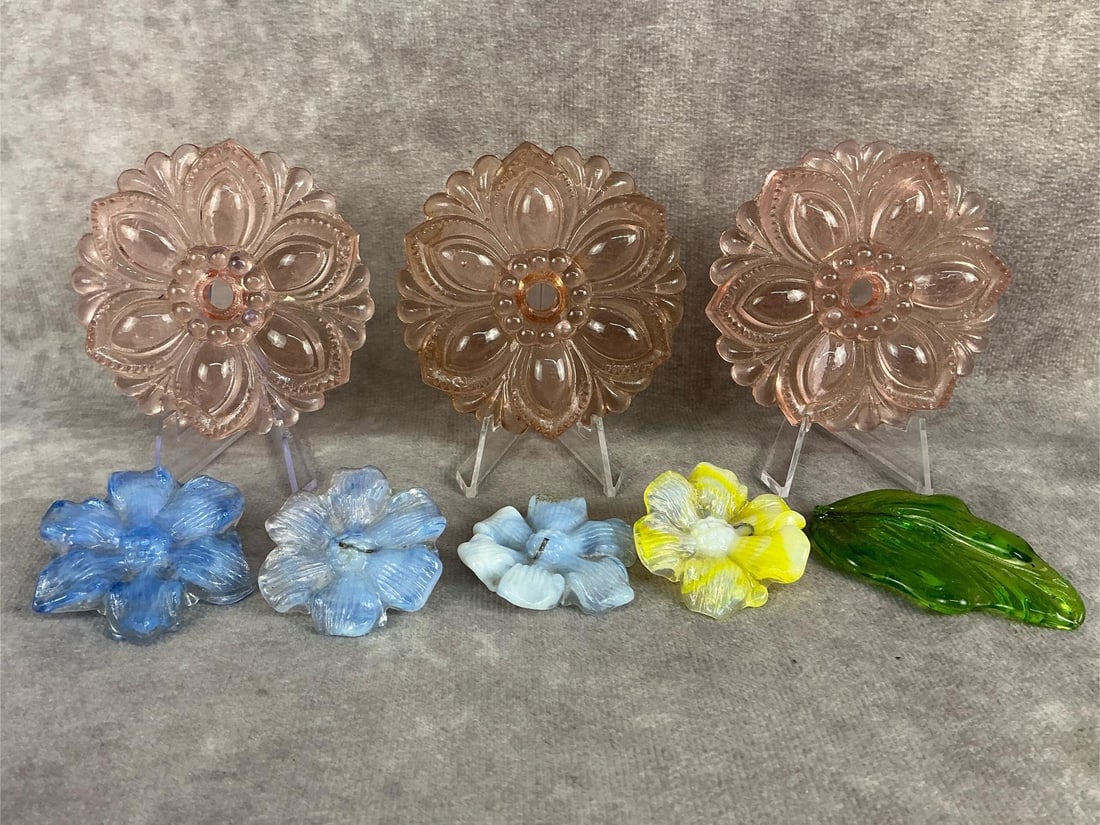 Victorian Glass Tiebacks: Three matching Victorian pink glass floral curtain tiebacks, three matching blue and white glass floral embellishments, one yellow and white glass floral embellishment, and one green glass leaf. Good