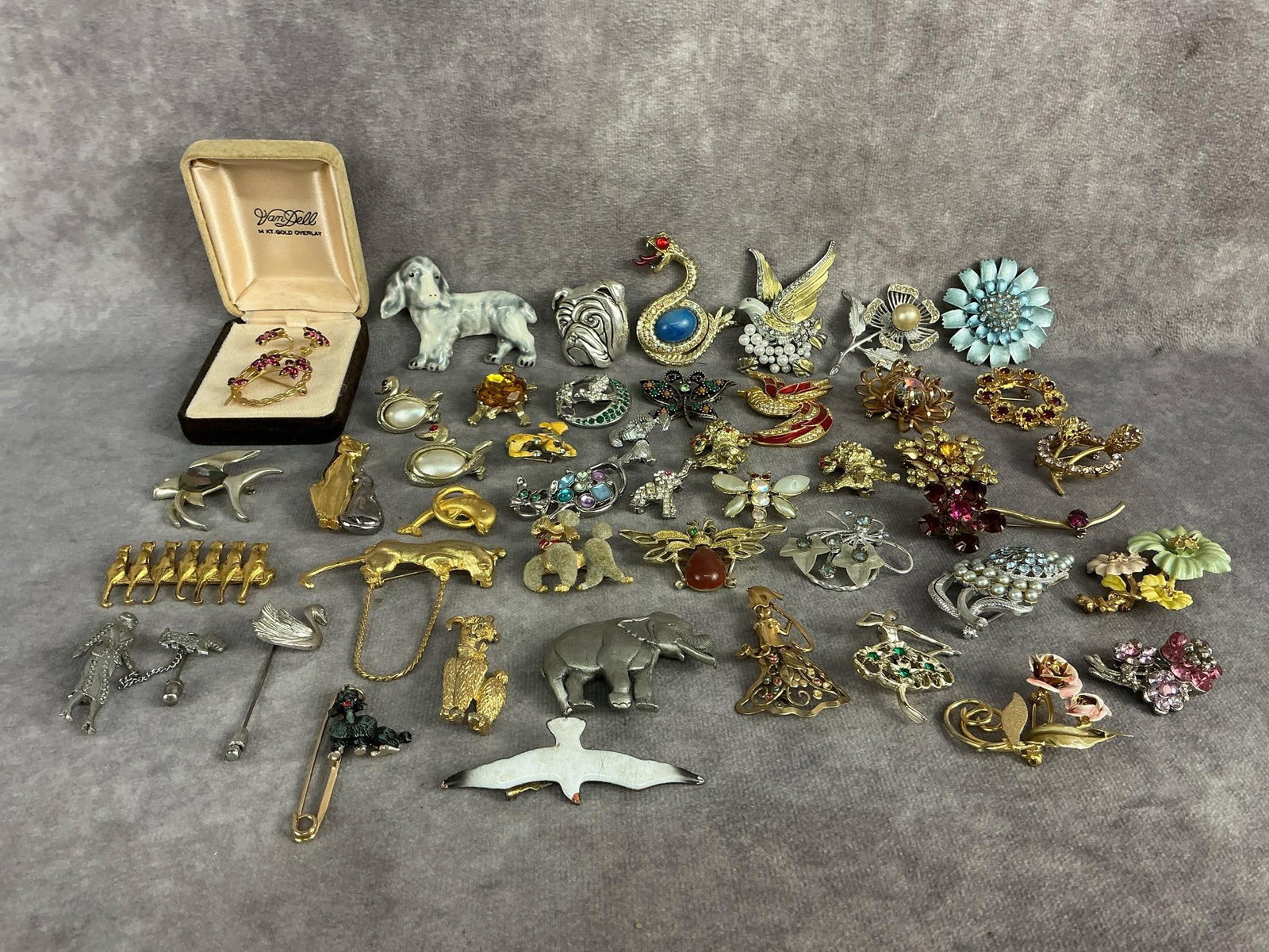 Costume Jewelry: Forty five pieces of vintage costume jewelry brooches and pins. Includes dogs, cats, elephants, butterflies, insects, and flowers. Brands include Sarah Coventry, Gerry's, Regel, Giorgio, and J.J..