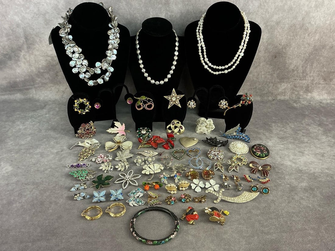 Costume Jewelry: Sixty pieces of vintage costume jewelry. Including brooches, clip on earrings, and pearl necklaces. Pearl necklaces include sweet water pearls, coin pearls, and natural freshwater pearls. One brooch