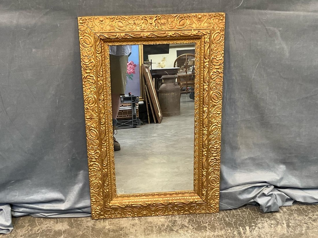 Victorian Mirror: Late 19th - early 20th century gilded mirror. Replaced glass and repainted, otherwise good condition. Measures 23 inches wide 1.5 x 35 inches tall.