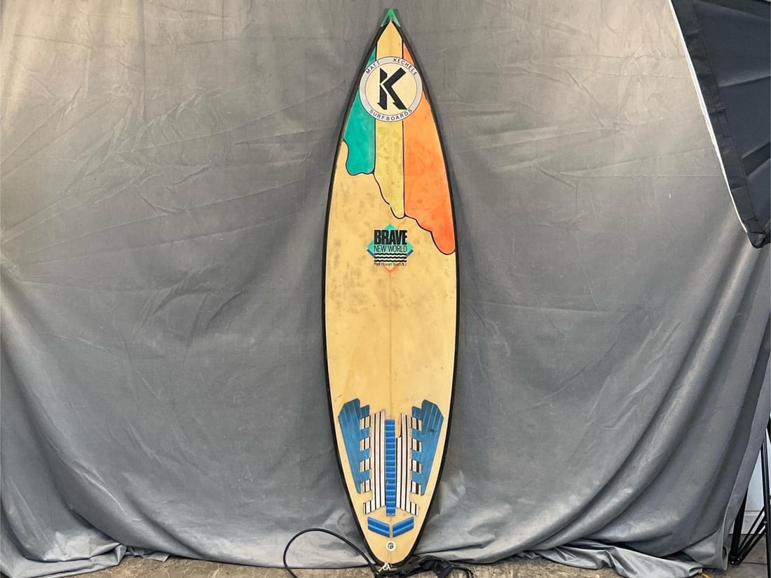 Surfboard: Vintage late 1970's - 1980's Matt Kechele surfboard with ankle leash from Brave New World Surf Shop Point Pleasant, New Jersey. Good used condition with visible marks to board and small indentation