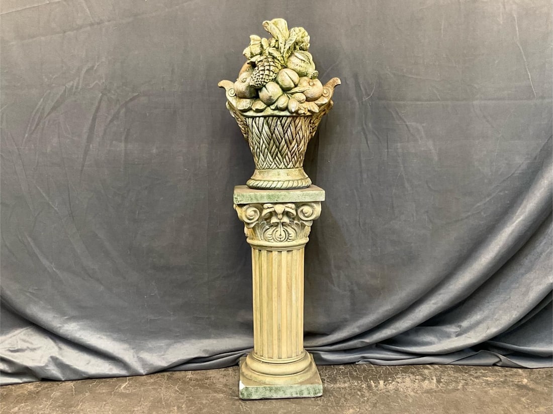 Garden Statuary: Late 20th century ceramic cornucopia on pedestal garden statuary. Small crack on fruit basket base and chip to pedestal base. Measures 10 inches wide x 10 x 42.5 inches tall.