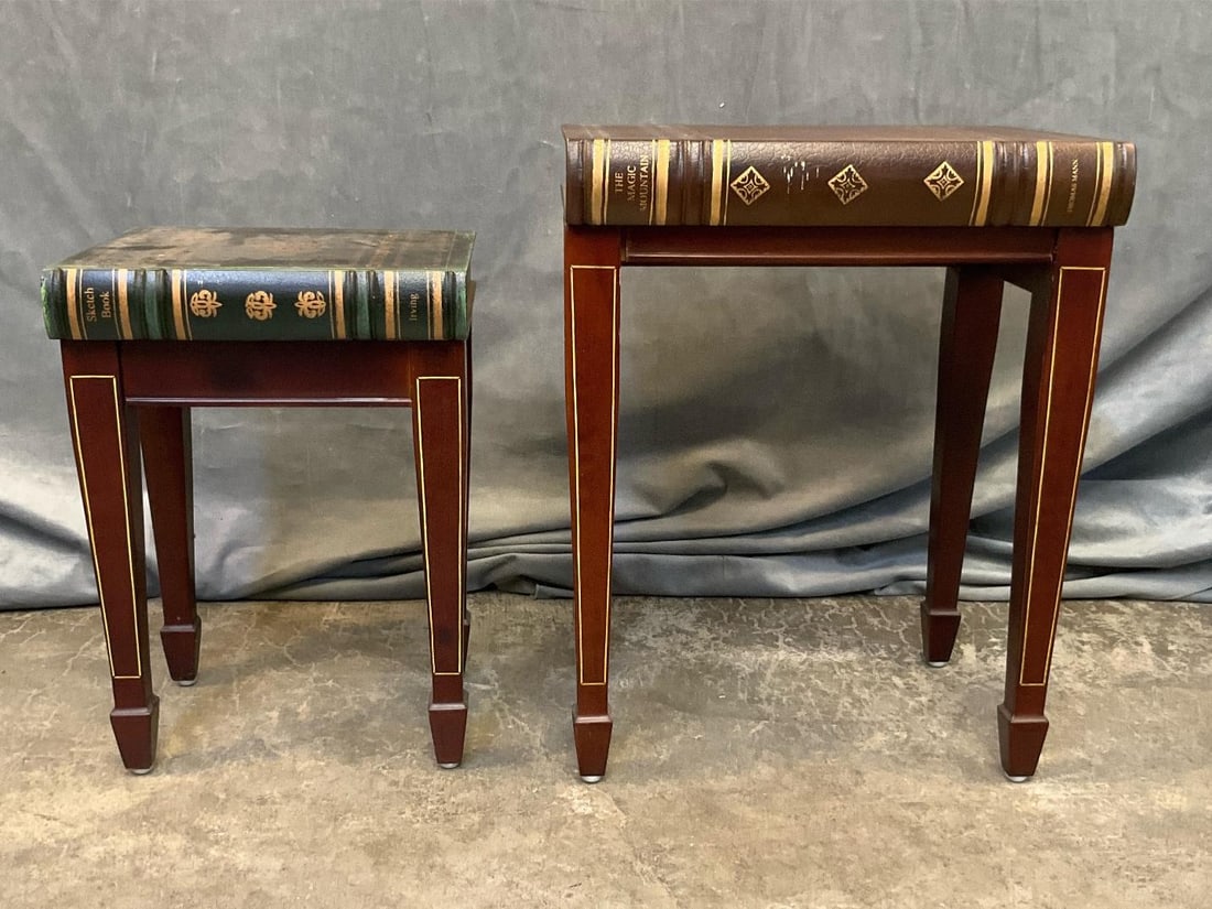 Two Decorative Book Stools: Modern reproduction decorative stools or pedestals in the form of antique leather bound books. Good condition. Largest measures 14.5 inches wide x 11.75 x 18.5 inches tall.