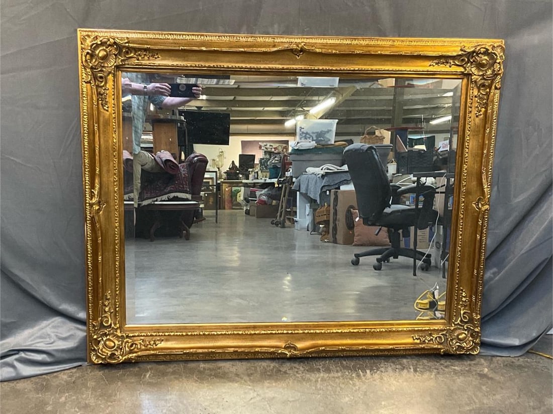 Mirror: Late 20th century gilt carved beveled mirror in the Rococo Style. Good condition. Measures 58.5 inches wide x 3.75 x 46.25 inches tall.