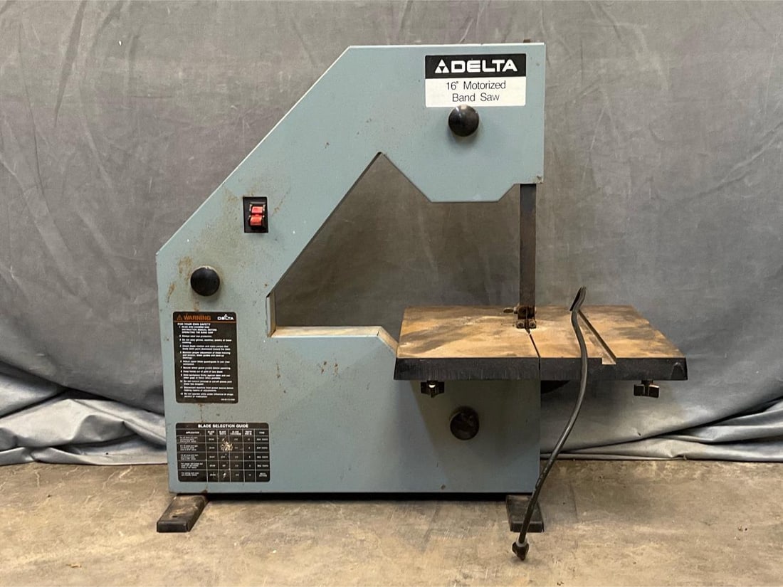 Band Saw: Circa 1980 Delta 16" Motorized Band Saw. Powers on, appears to function. Measures 31.5 inches wide x 19 x 29 inches tall.