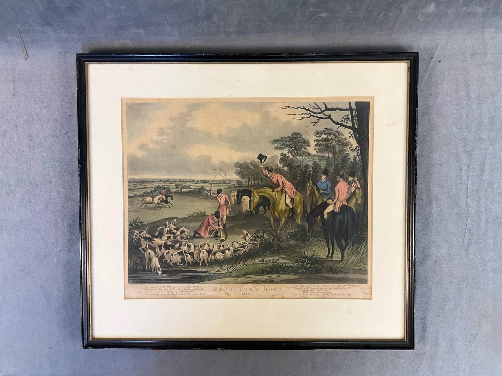 Fox Hunting Print: 19th century British fox hunting framed and matted engraving titled "Bachelor's Hall". Plate 5 of set. Water stain damage, foxing discoloration and paint loss to frame. Measures 19 inches wide x .5 x