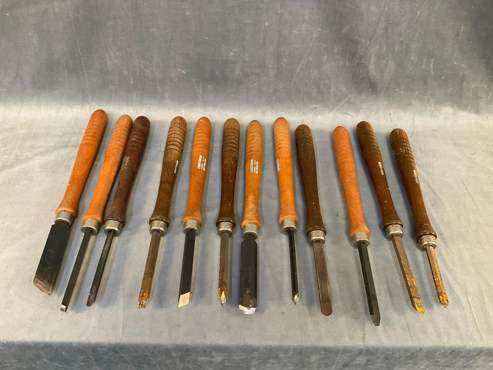 Lathe Tools: Early 2000's lot of twelve Craftsman High Speed Steel Wood Lathe Turning Tools. Good condition with light surface rust. Measures 1.25 inches in diameter x 13.5 inches tall.
