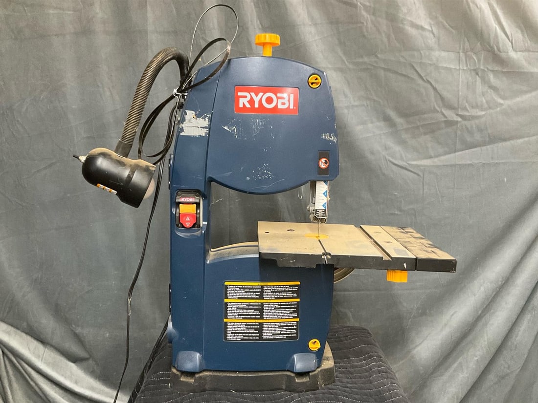 Band Saw: 1980's RYOBI 9 inch Band Saw BS903 with light attachment. Light works, saw powers on but not tested. Measures 23 inches wide x 10 x 30 inches tall.