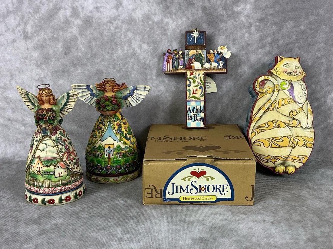 Jim Shore Figures: Four Jim Shore figures including a cat trinket box, two angels, and a nativity scene cross ornament with original box and tag. One angel has a broken wing, otherwise in good condition. Box measures