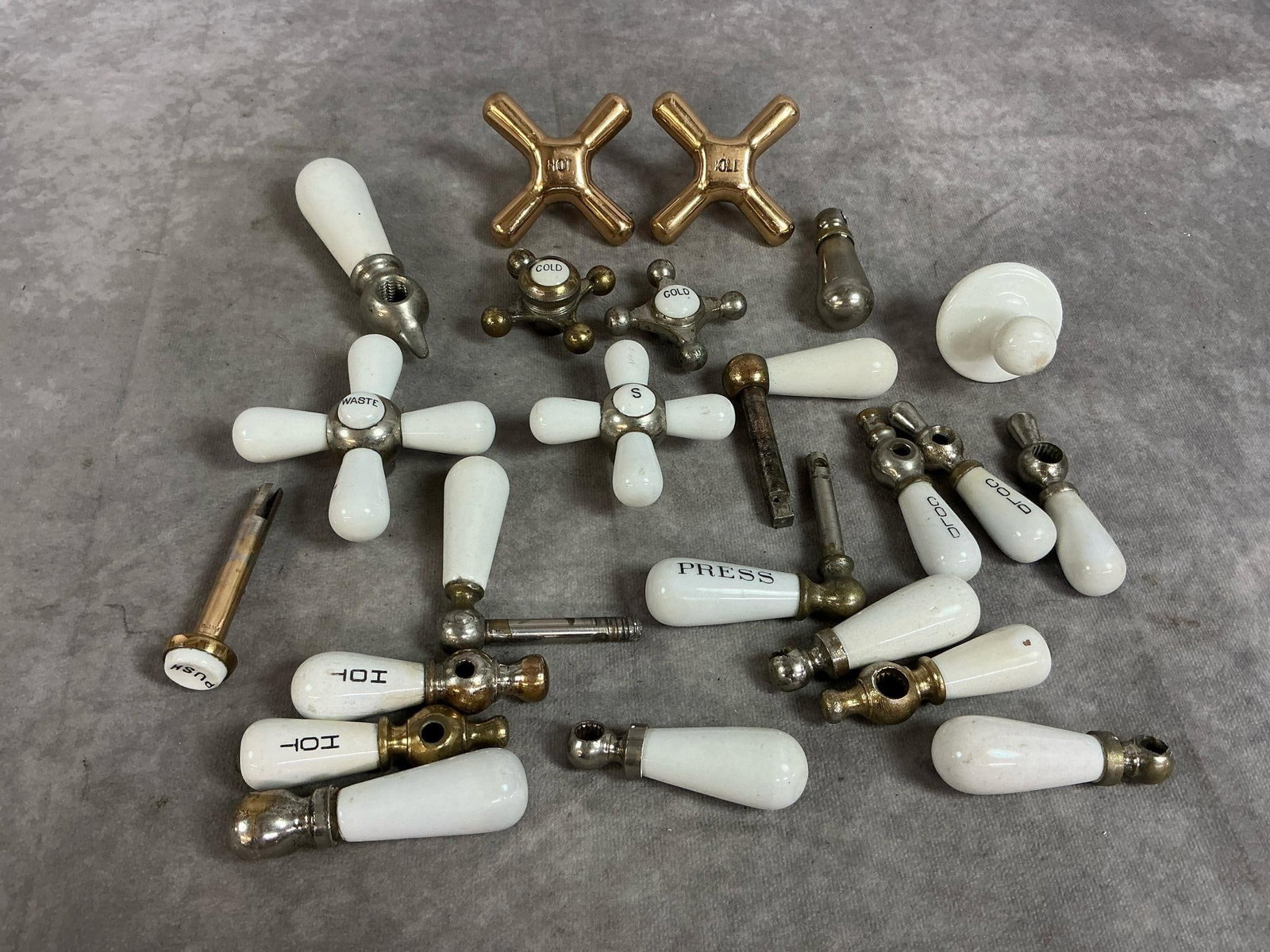 Antique Sink Hardware: Twenty four vintage porcelain sink hardware. Includes knobs, and handles. Some paint loss, otherwise in good condition. Largest handle measures 1.25 inches wide x 4.5 inches long.