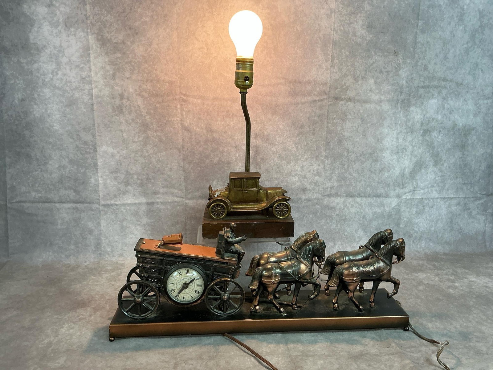 Brass Horse Carriage & Antique Car Lamps: Two mid 1900's decorative lamps and clock. Sessions brass horse carriage with light and clock - untested. Brass Model A Roadster lamp on wooden block - working lamp. Both have tarnish and paint