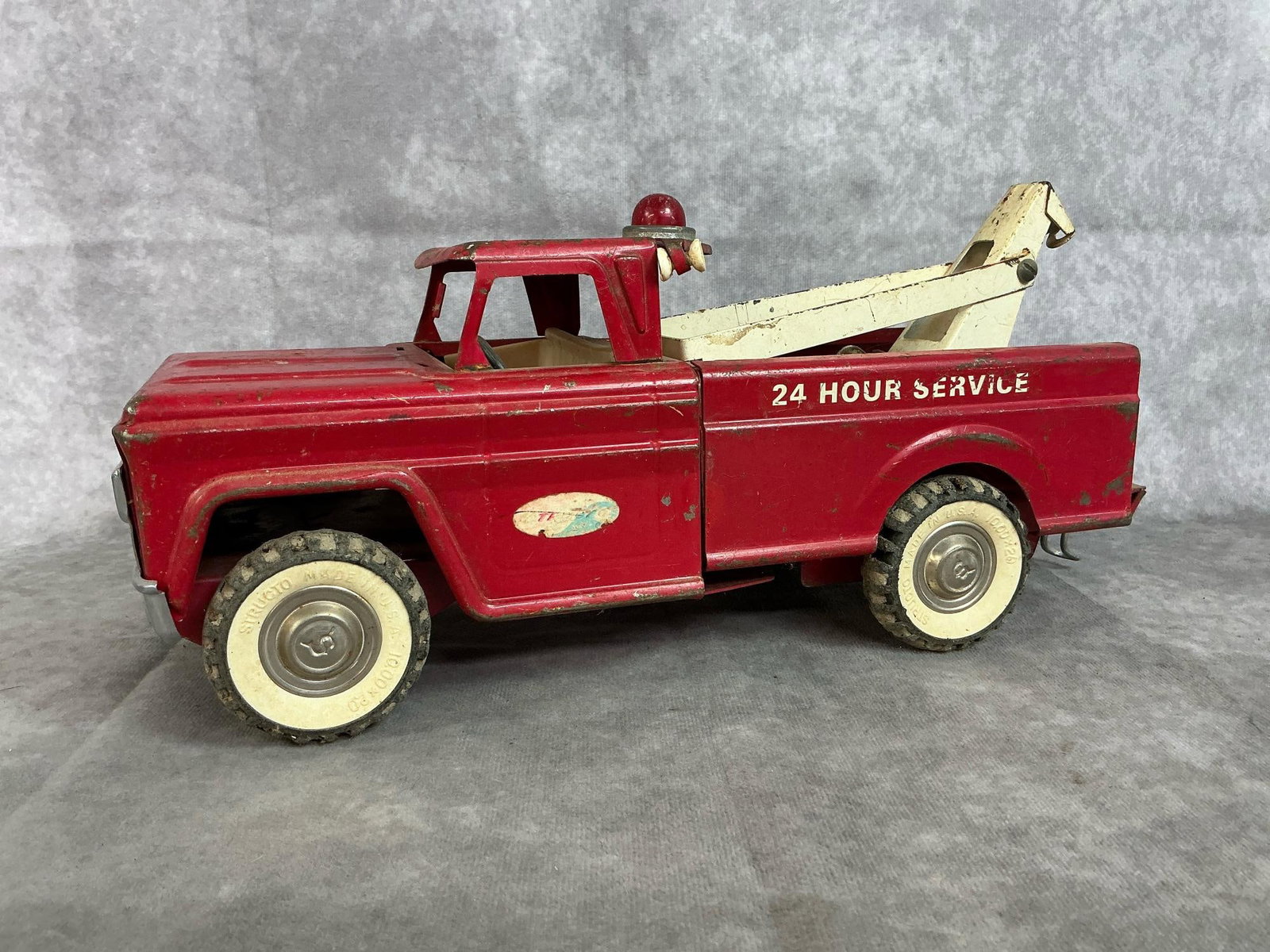 Structo Tow Truck: 1950's Structo toy wrecker tow truck. Metal with rubber tires. Some rust and paint loss. Measures 13 inches long x 5 x 5.5 inches tall.