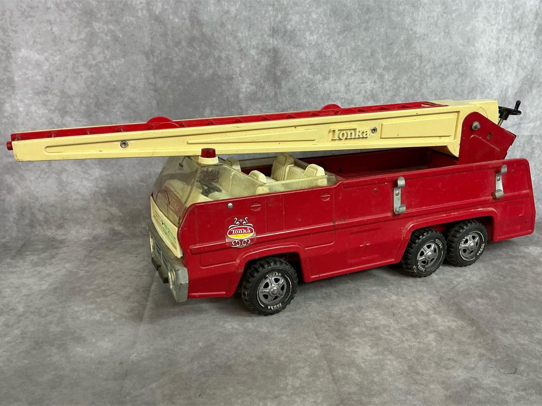 Tonka Ladder Truck: 1970's Tonka red fire truck with extension ladder. Pressed steel body with plastic ladder and cab. Slight rust present. Truck body measures 19.5 inches long x 6 x 8.5 inches tall.