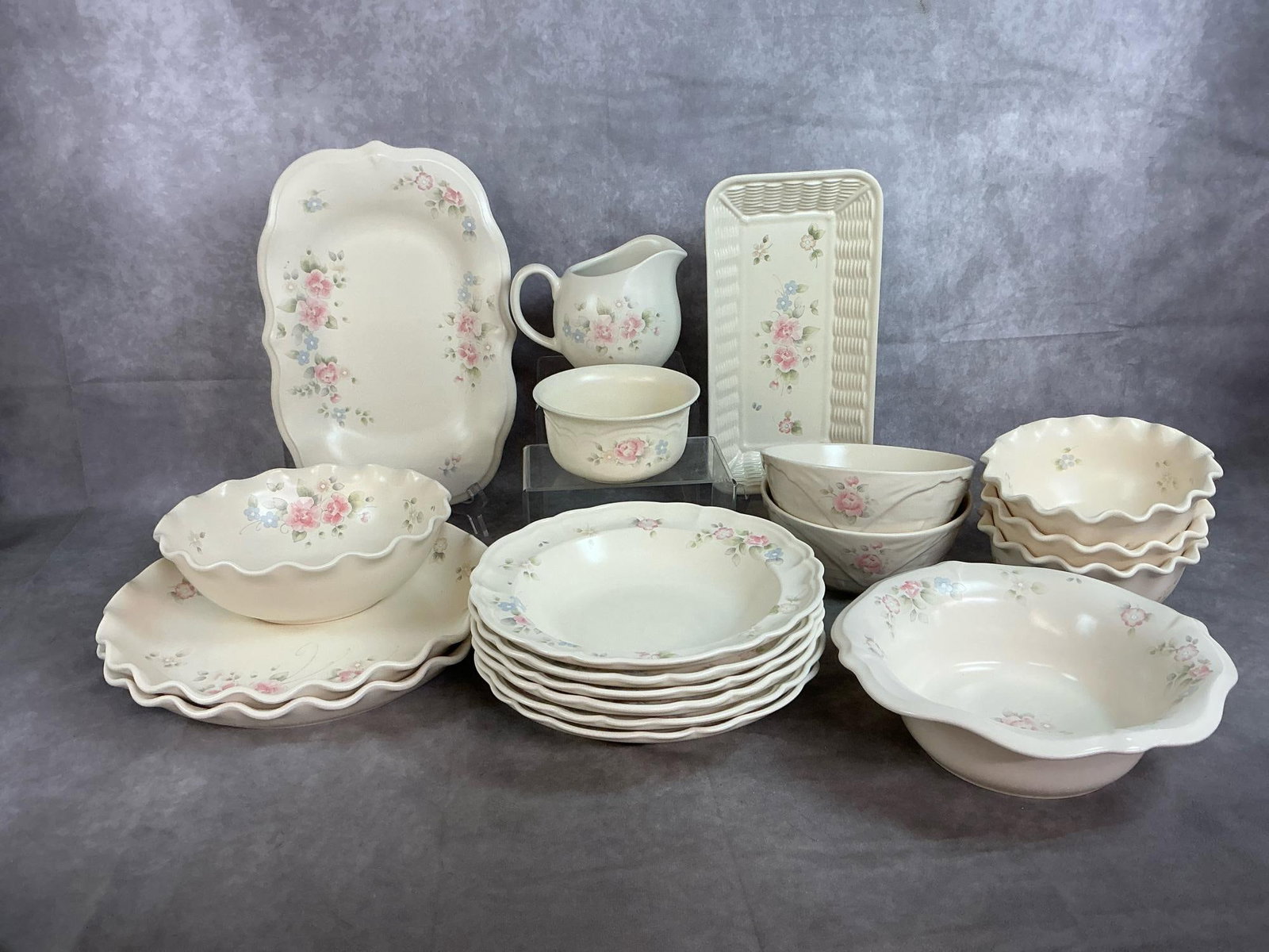 Pfaltzgraff Tea Rose Set: Eighteen pieces of Pfaltzgraff Tea Rose pattern serving dishes. Cream colored with pastel rose, blue and green pattern. Includes 6 salad bowls, 2 round fluted platters and a long platter, 2 serving