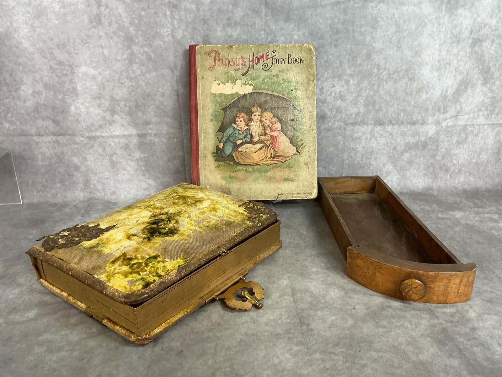 Antique Photo Book, Drawer, & Story Book: Three late 1800's to early 1900's items. Ornate photo album with pictures, sewing machine oak drawer, and Pansy's Home Story Book. Book and album are worn with some discoloration. Album measures 9