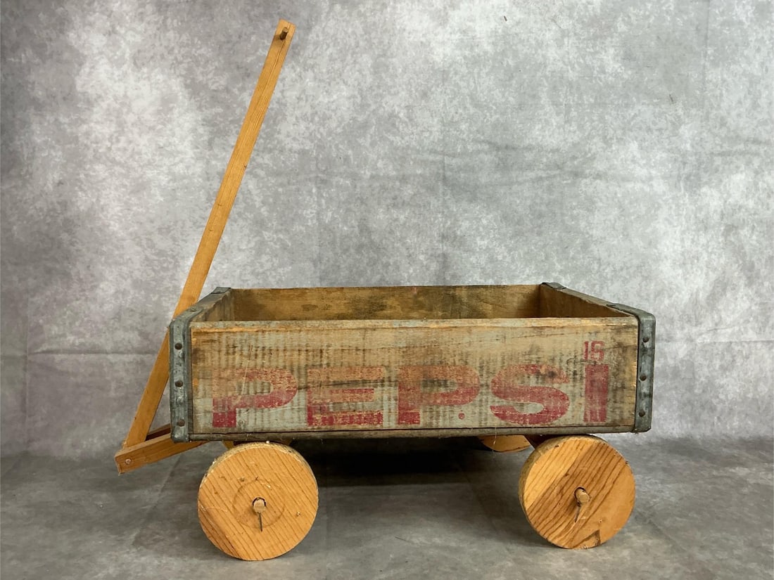 Pepsi Crate Wagon: Vintage wooden Pepsi crate wagon. Homemade wheels and pull handle attached to rustic vintage crate. Wood is worn. Crate measures 18 inches long x 12 x 9.25 inches tall with wheels.
