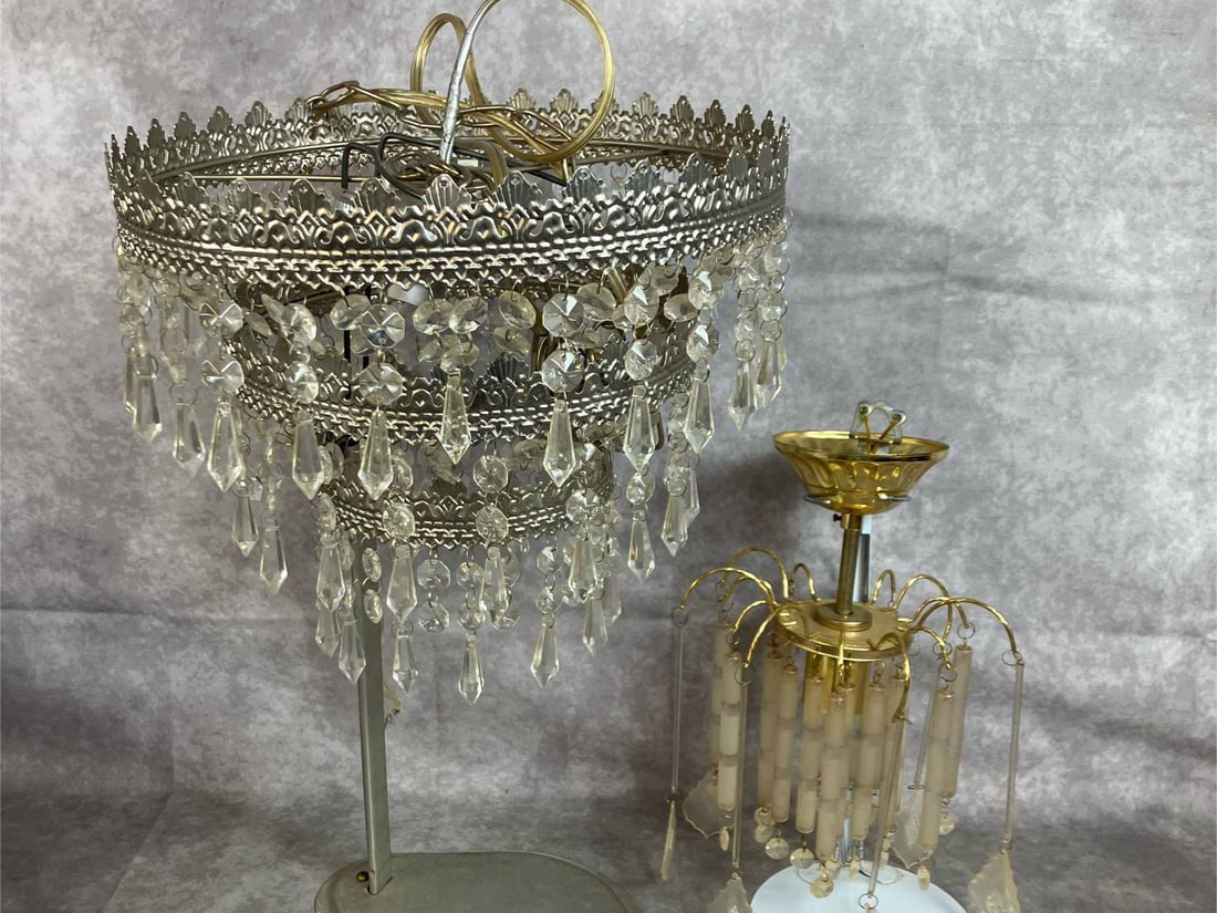 Crystal Prism Chandeliers: Two mid 1900's Art Deco chandeliers. Round metal and crystal pendant hanging lamp with chain, and gold tone glass pendants hanging lamp. Untested. Larger round lamp measures 12 inches in diameter x