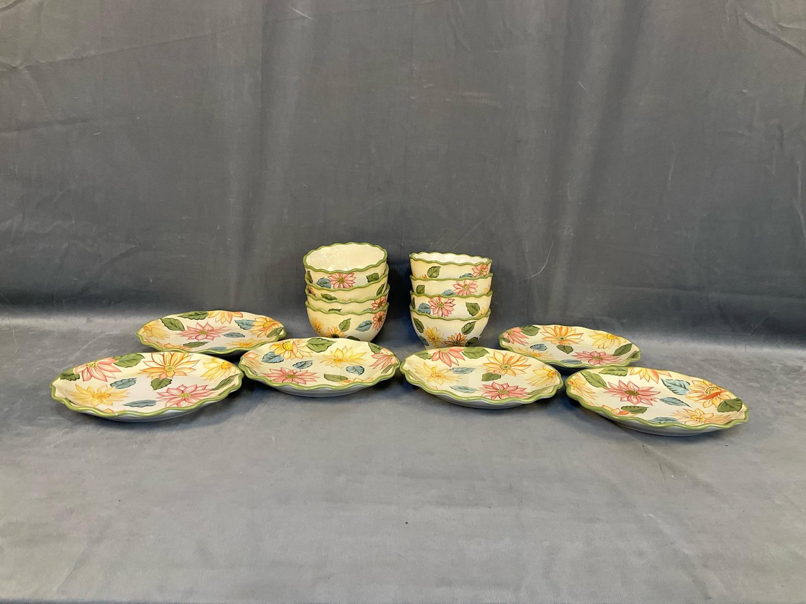 Longaberger Pottery: Lot of fourteen late twentieth century floral decorated Longaberger plates and bowls. Eight bowls and six plates. Good condition. Plates measure 9.25 inches in diameter x 1.25 inches tall.