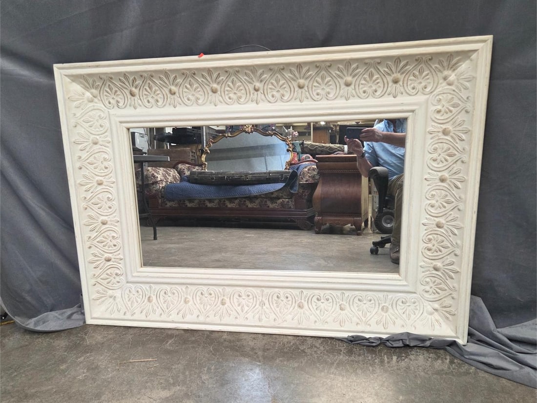Wall Mirror: Late 20th century white floral decorated molded mirror. Some scratches to paint, otherwise good condition. Measures 56.75 inches wide x 3.75 x 39 inches tall.