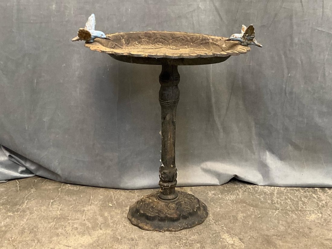Cast Iron Birdbath: Late 20th century cast iron birdbath with two cast iron birds perched on rim. Outdoor wear, otherwise good condition. Measures 17.5 inches wide x 10.5 x 20 inches tall.