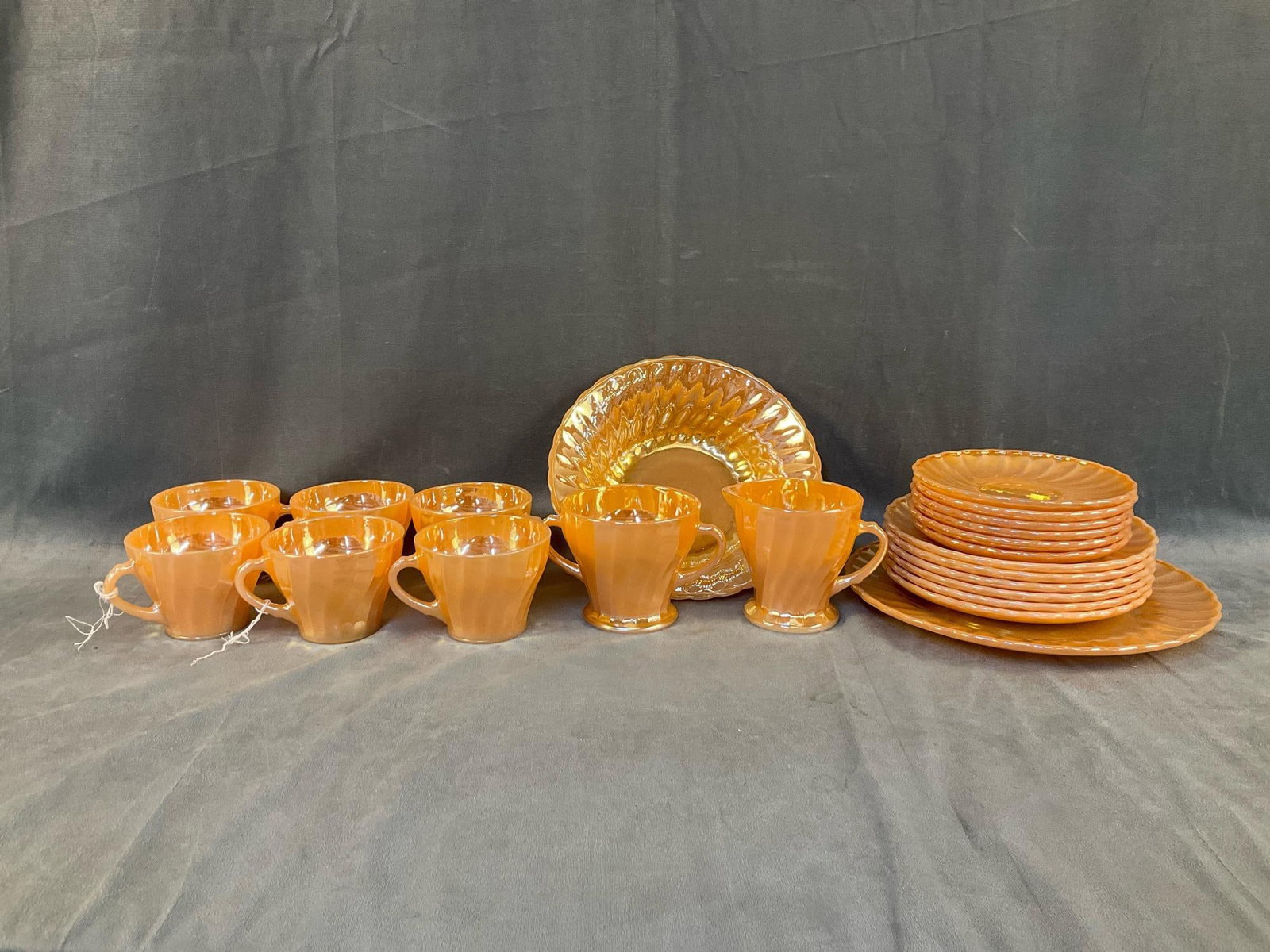 Fire King Orange Lustre: Mid - 20th century set of Anchor Hocking Fire King Orange Lustre Dinnerware. All marke Anchor Hocking. Six cups with six saucers, one dinner plate, one creamer, one sugar, one serving bowl, and six sa