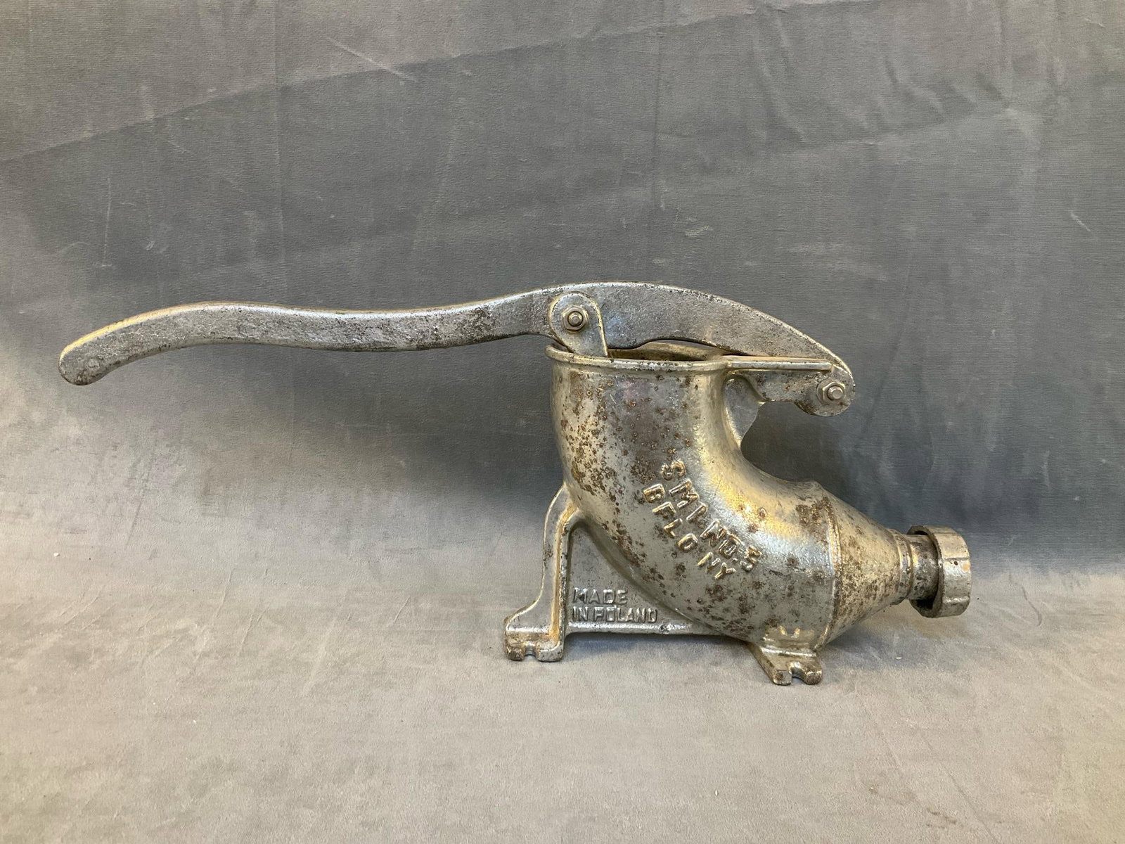 Sausage Stuffer: 1960's cast iron SMI No. 5 Polish Sausage Stuffer, Buffalo, N.Y., Made in Poland. Some loss to tin coating, otherwise good condition. Measures 21 inches wide x 4 x 8.25 inches tall.