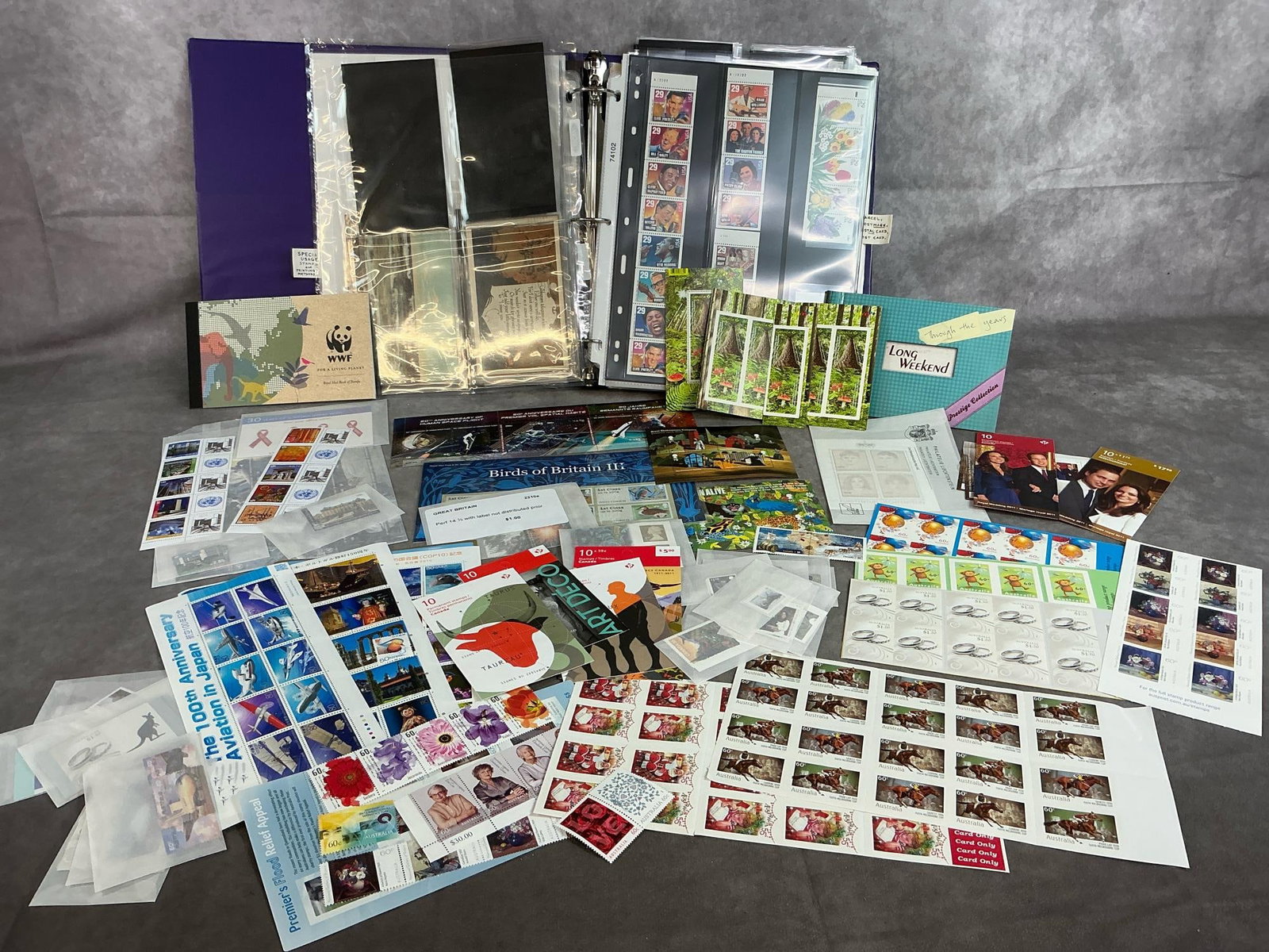 Stamp Collector's Finds: Large lot of a variety of late 1900's to early 2000's stamps and stamp instructions binder. Collectible stamps from US, Britain, Australia, Canada, and Japan. Books, half books, sheets, and