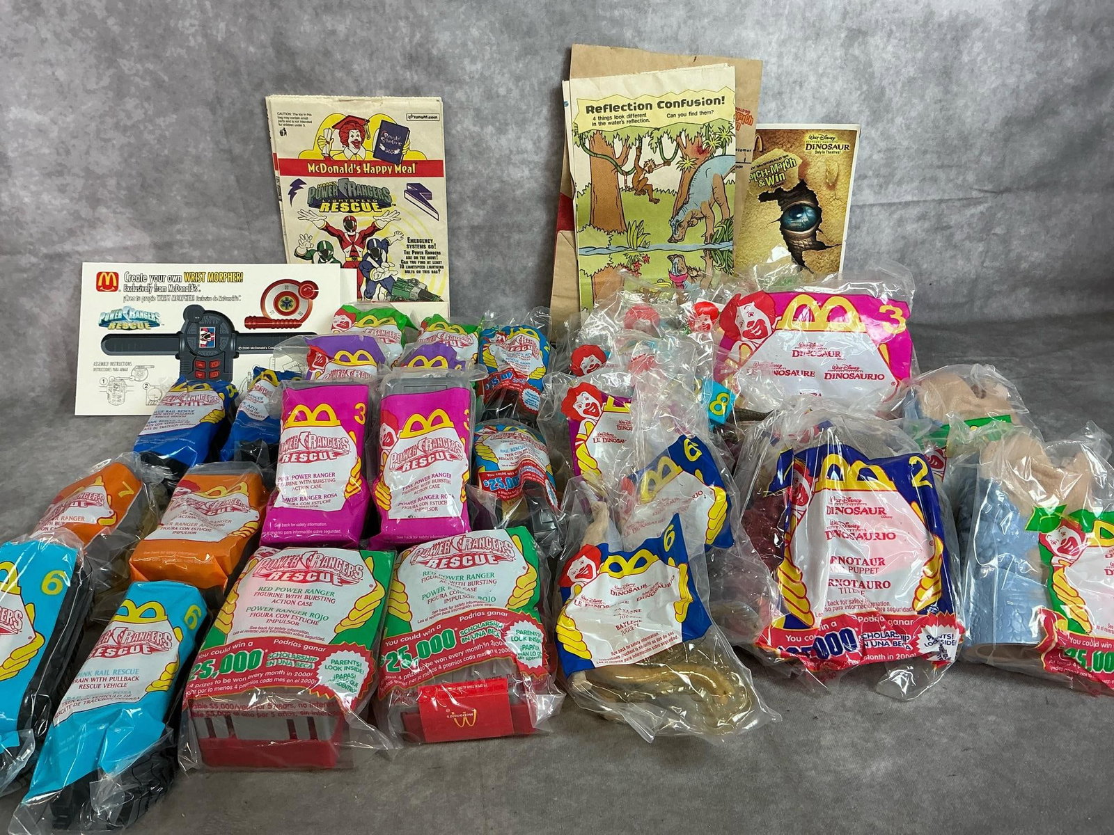 Happy Meal Toys: Thirty-two 2000 year McDonald's toys. Power Rangers Rescue and Dinosaur Movie figures. In original packaging. Average size 4 inches wide x 5 inches tall.