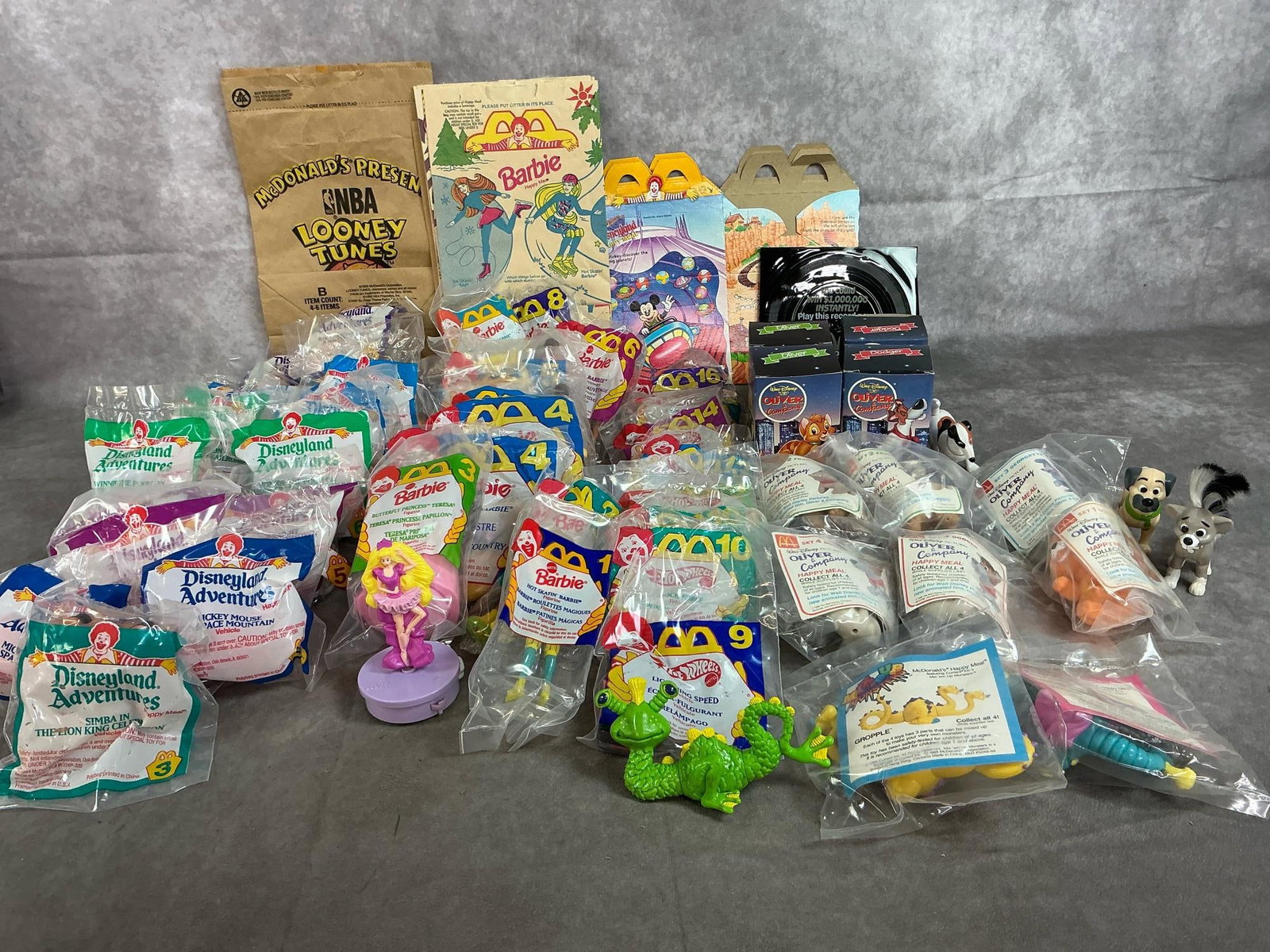 Vintage McDonald's Toys: Fifty 1986-1994 Happy Meal toys. Includes Oliver & Company, Barbie, Disneyland Adventures, Hot Wheels and Mix 'em Up Monsters. Includes bags and 2 records. Average size package is 4 inches wide x 5
