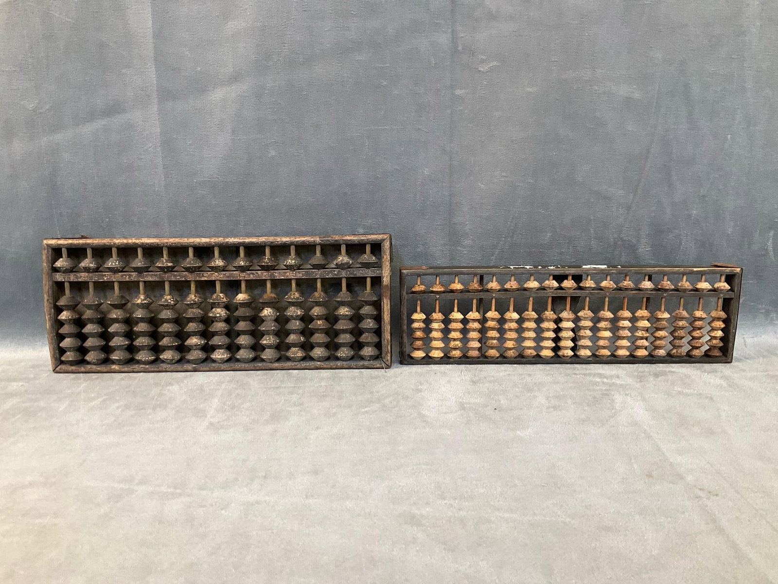 Chinese Abacuses: Two early 20th century wooden abaci. One abacus with illegible Chinese writing. Good condition. Larger one measures 11.5 inches wide x 1.25 x 4.5 inches tall.