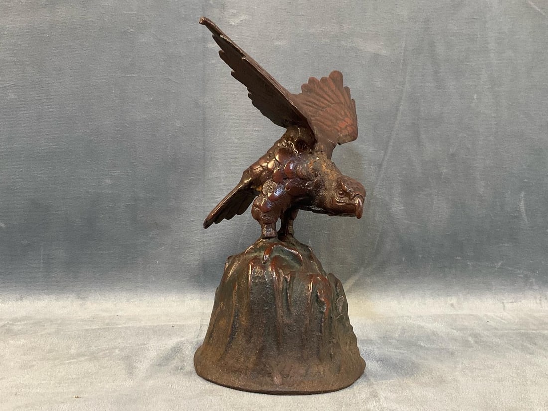 Cast Iron Eagle: Late nineteenth century - early 20th century cast iron eagle perched on rock. Good condition. Measures 4.5 inches wide x 4.5 x 8 inches tall.