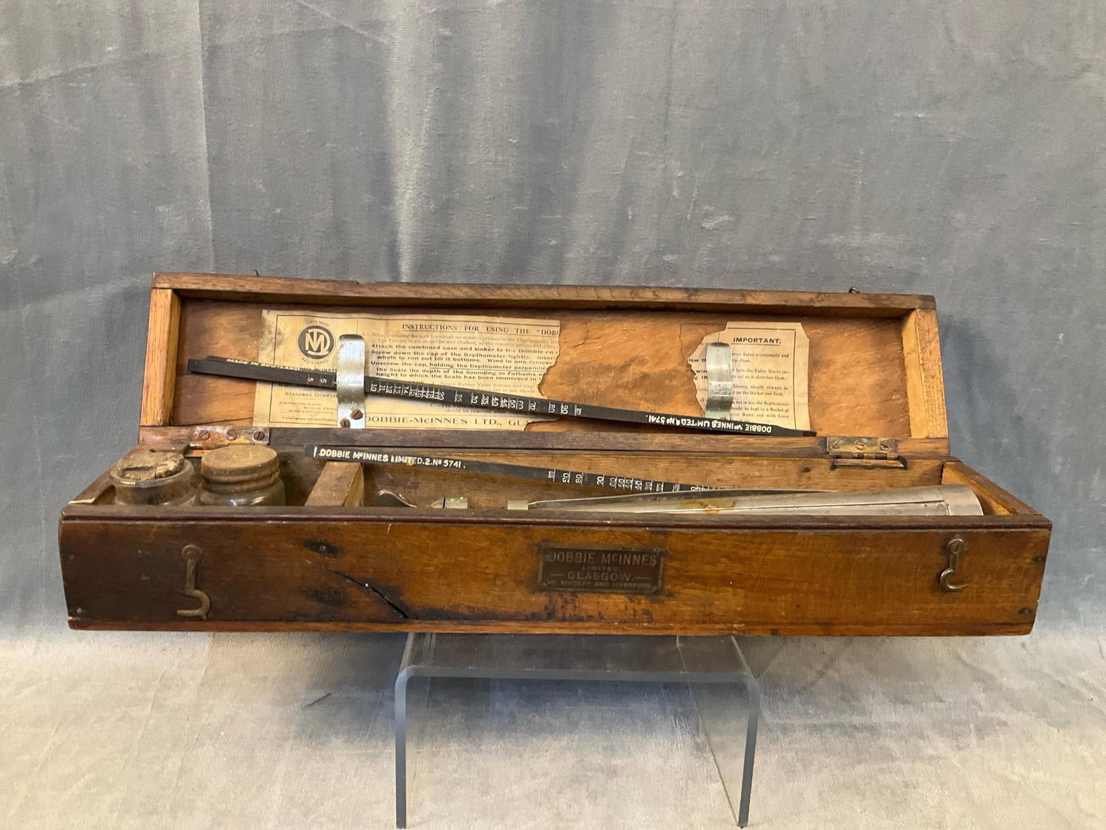 Water Depth Finder: Early 20th century Dobbie McInnes Limited Glasgow, Scotland water depth finder in original wooden case with original paper instructions. Several splits to case, otherwise good condition. Case