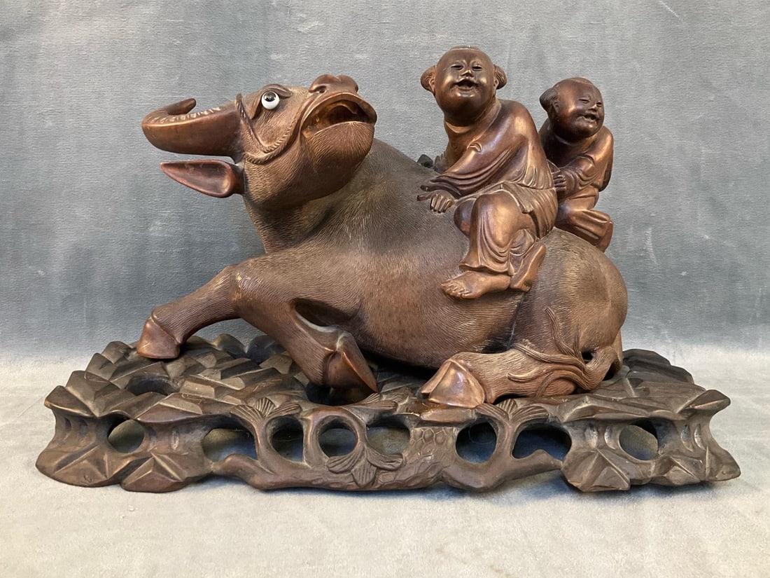 Chinese Carving: Mid - twentieth century Chinese hand wrought wooden water buffalo with children carving on original stand. Good condition. Measures 14.5 inches wide x 5.5 x 9 inches tall.