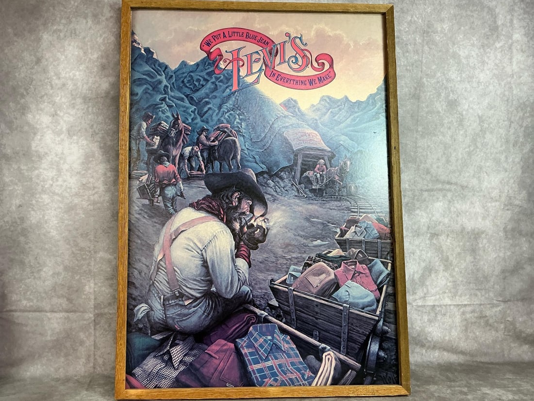 Levi's Framed Poster: 1970's Levi Jeans poster. Wooden framed Miners poster, " We Put a Little Blue Jean in Everything We Make". In good condition. Measures 23 inches wide x 32 inches tall.