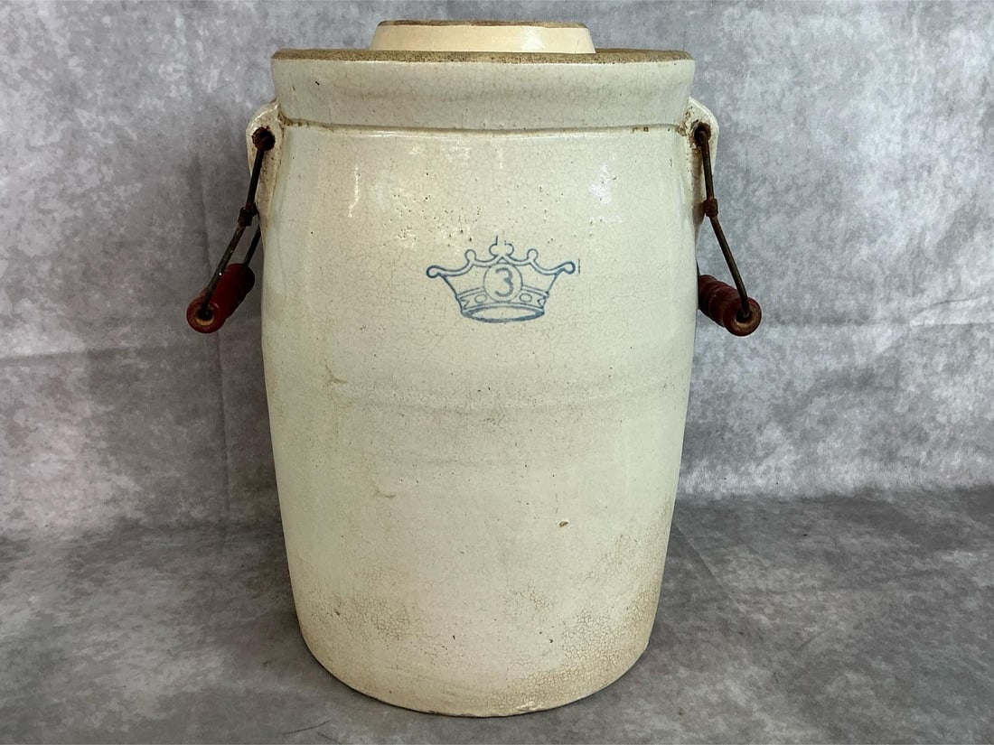 Butter Churn Crock: Vintage three gallon butter churn with lid. Robinson Ransbottom Blue Crown number 3 churn with wooden and wire handles. Rust on handles, otherwise in good condition. Measures 9 inches in diameter x