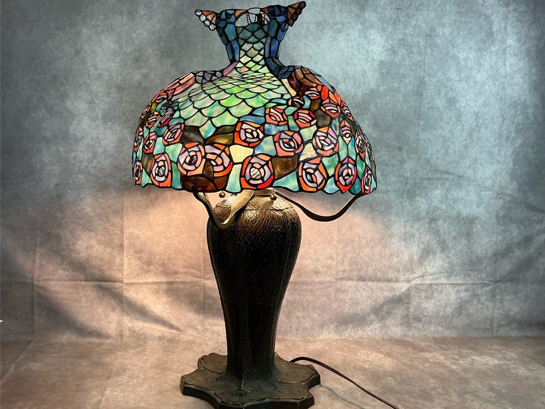 Peacock Stained Glass Lamp: Vintage stained glass lampshade and metal lamp. Three bulb electric lamp with individual pull chains. Peacock design on shade and metal base. In good condition, tested and working. Measures 10.5