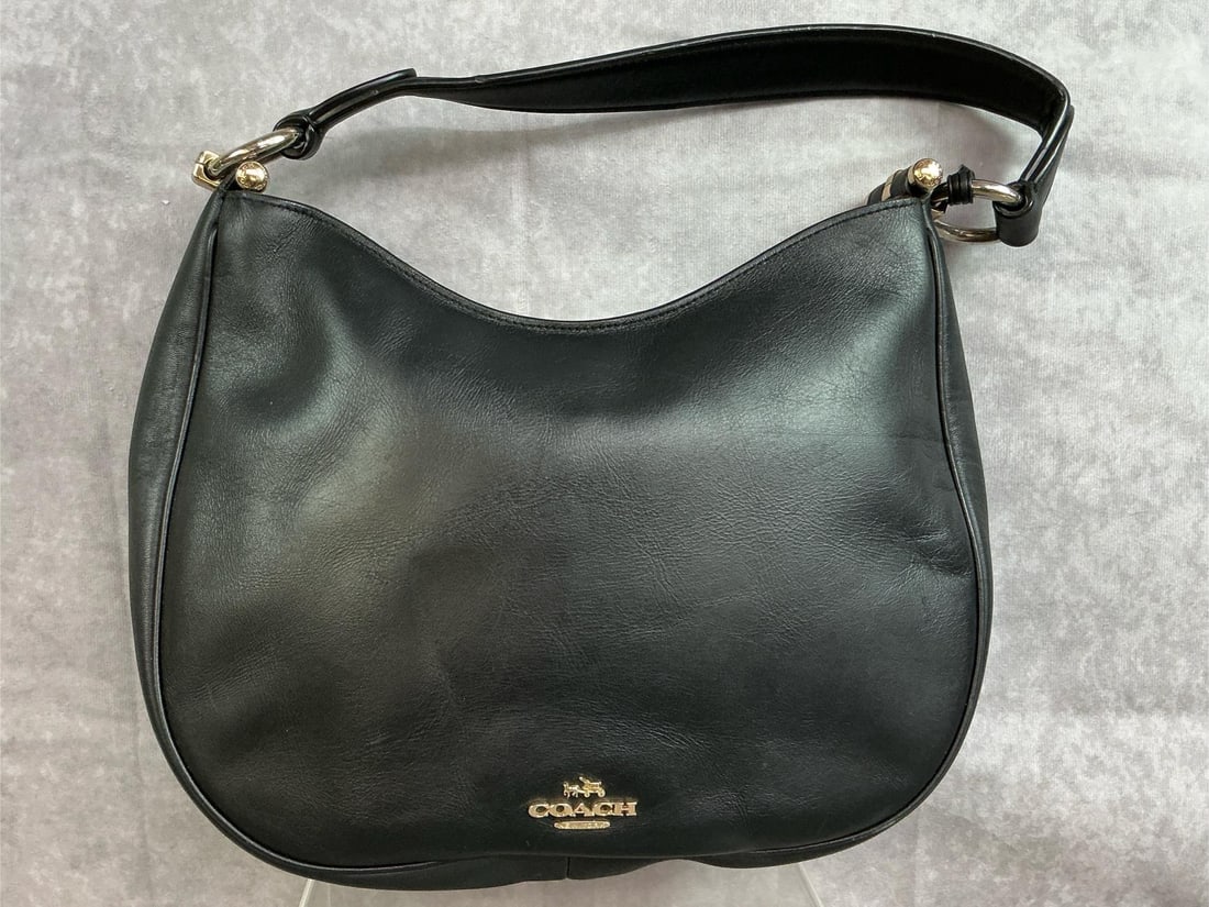 Coach Hobo Handbag: 2017 leather Coach Hobo handbag with tan leather interior, and brass colored hardware. Two interior side pockets, and one interior zippered pocket. Leather patch tag has serial number K1781-F54446.