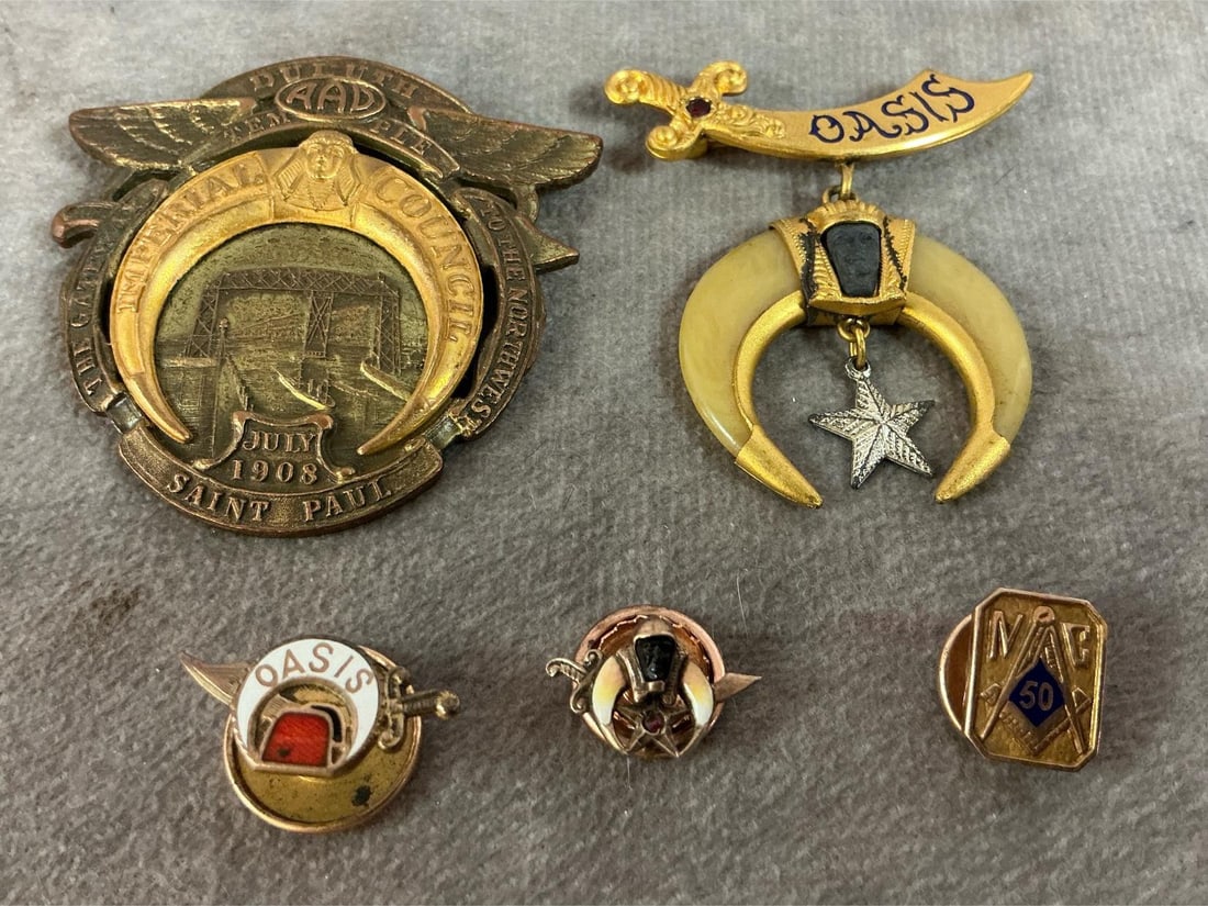 Masonic & Shriners Pins: Five early 1900's pins and badges. Imperial Council of "AAD Temple" 1908 badge, and Shriner's Oasis with gold scimitar badge. Includes two Shriners tack pins and a 10kt gold Mason's 50 year pin