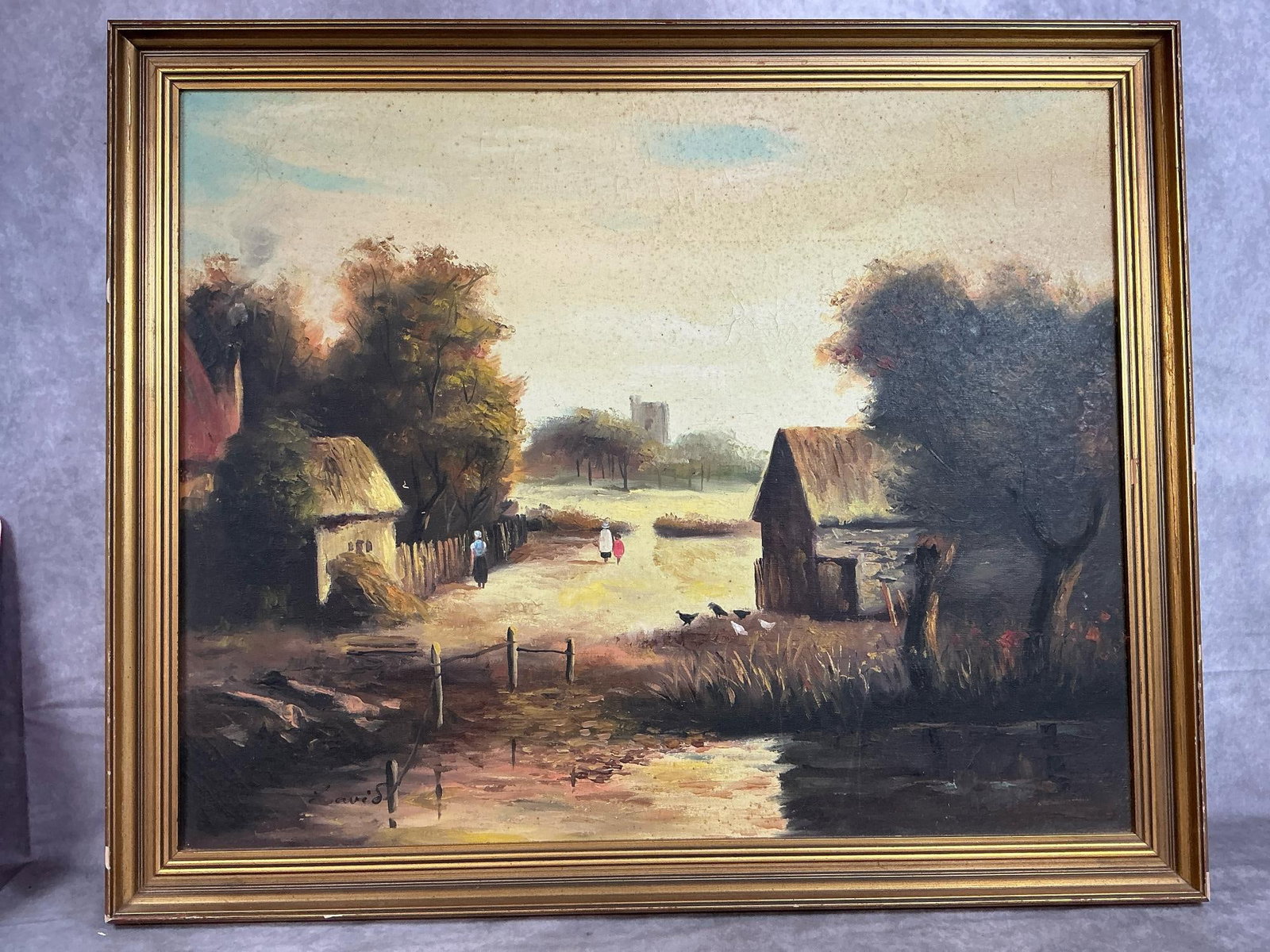Country Scene on Canvas: Vintage oil painting. Original framed artwork of country village. Signed by artist. Some cracks and blemishes on painting. Measures 33 inches wide x 1.5 x 27 inches tall.