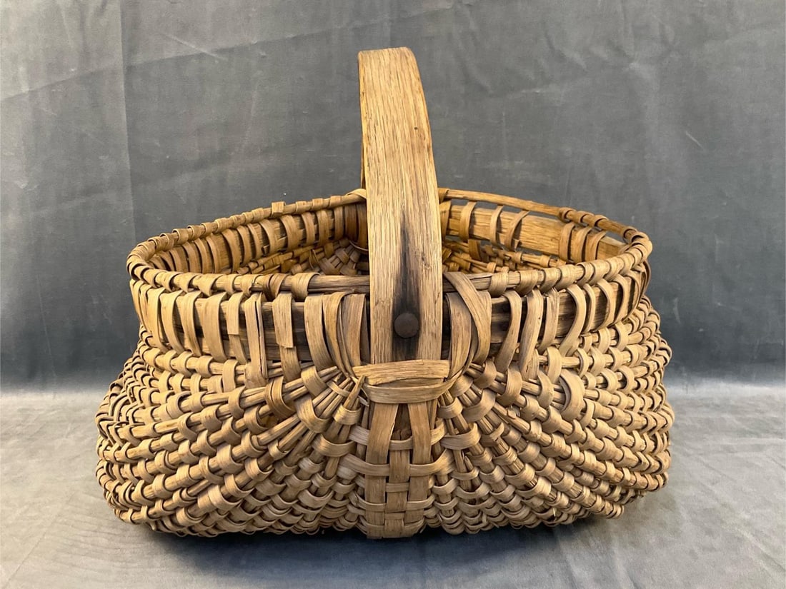 Splint Kidney Basket: Late 19th - early 20th century Southern Appalachian rib-type, white oak splint, kidney form, wrapped double rim, and riveted handle basket. Probably Virginia. Some losses and breaks. Measures 16 inche