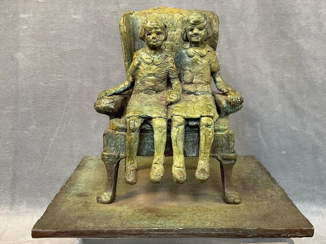 Bronze Sculpture By Jack Witt: 1994-95 bronze sculpture depicting two young girls seated on a Chippendale wingback chair. Signed and dated inscription on the base/floor at the left rear " Sisters”, "J. Witt 94'-95' ".
