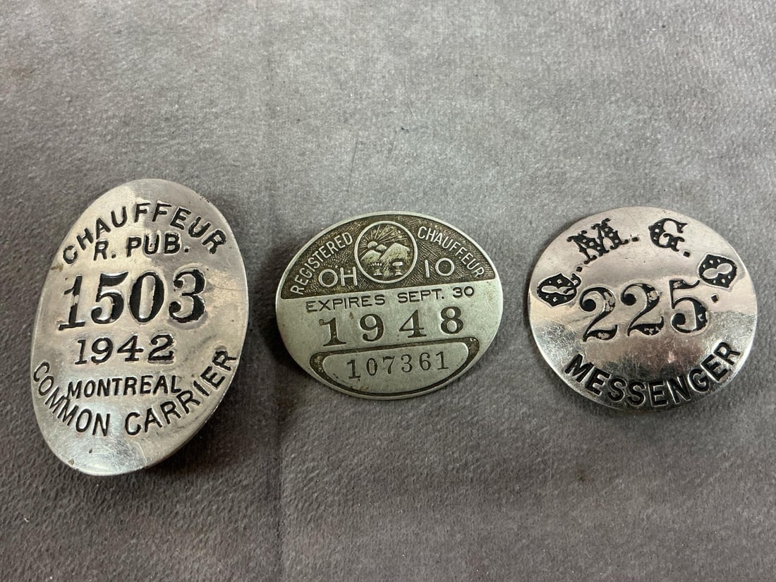 Quartermaster's & Chauffeurs Badges: Three early to mid 1900's badges. Q.M.G.O.- Quartmaster General's Office Messenger from NY 1920's badge. Also, Montreal Chauffeur 1942 badge, and Ohio Chauffeur 1948 badge. In good condition. Largest