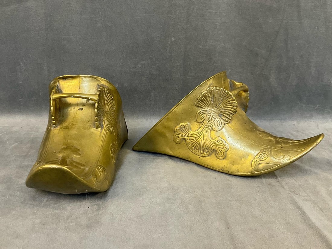 Spanish Colonial Stirrups: 19th century pair of Conquistador Style South American patinated brass horse saddle stirrups with decorated Mayan or Aztec masks. Signs of wear commensurate with age and use, otherwise good