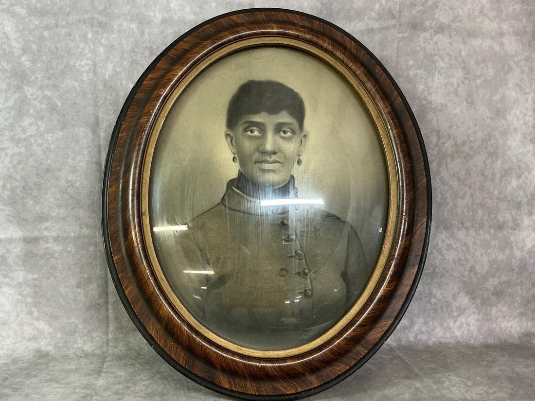 Portrait of a Lady: Late 1800's to early 1900's portrait. Oval wooden frame with domed glass of African American or Middle Eastern lady. In good condition. Measures 13.5 inches wide x 1 x 16 inches tall.