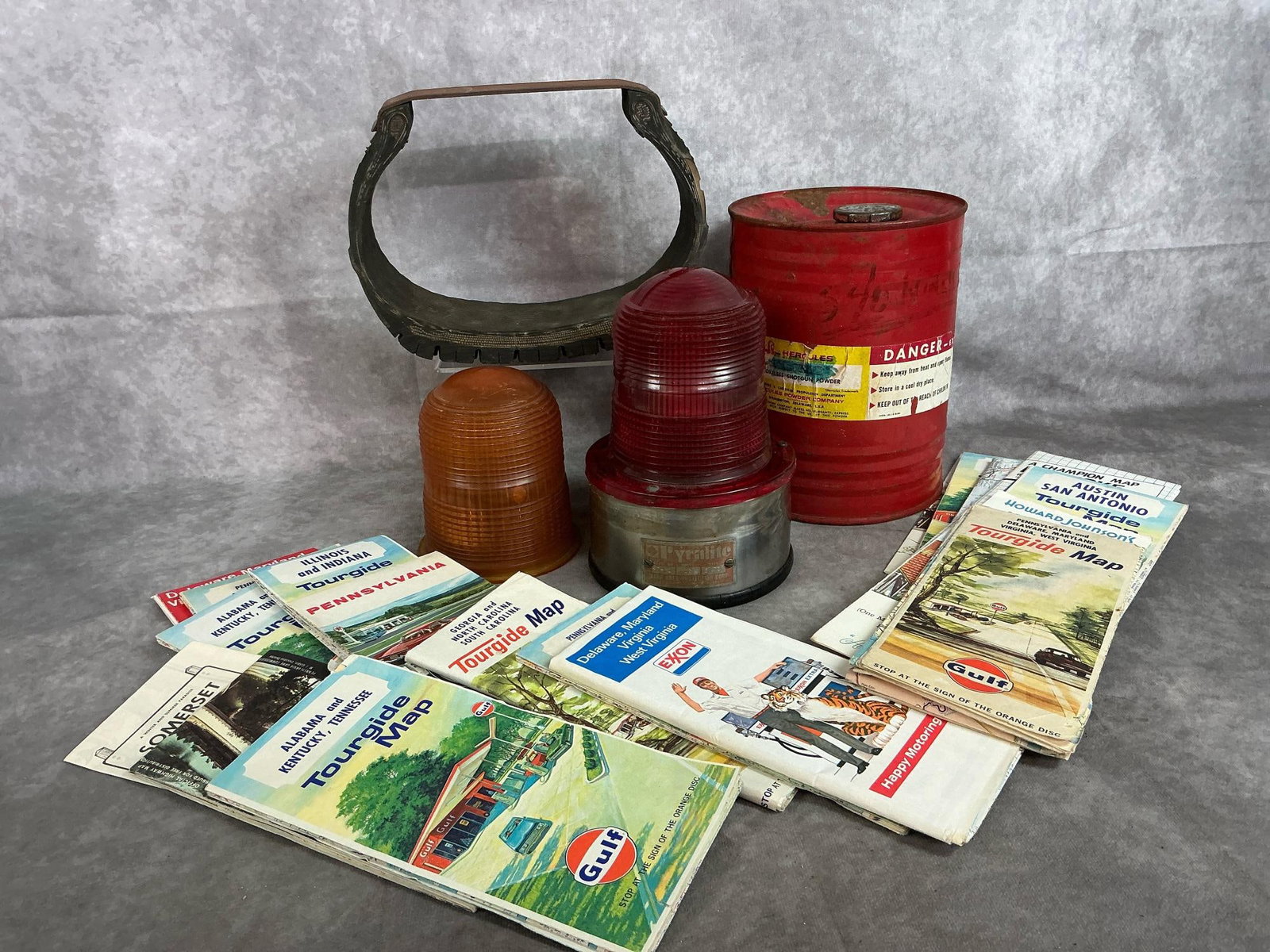 Travel Collection & Hercules Powder Can: Four vintage items and eighteen road maps. Pyralite signal light with two domed lenses, tire tread sample from tire store in Galax, VA, and Hercules Shot Gun Powder red barrel can. Gulf, Exxon, and