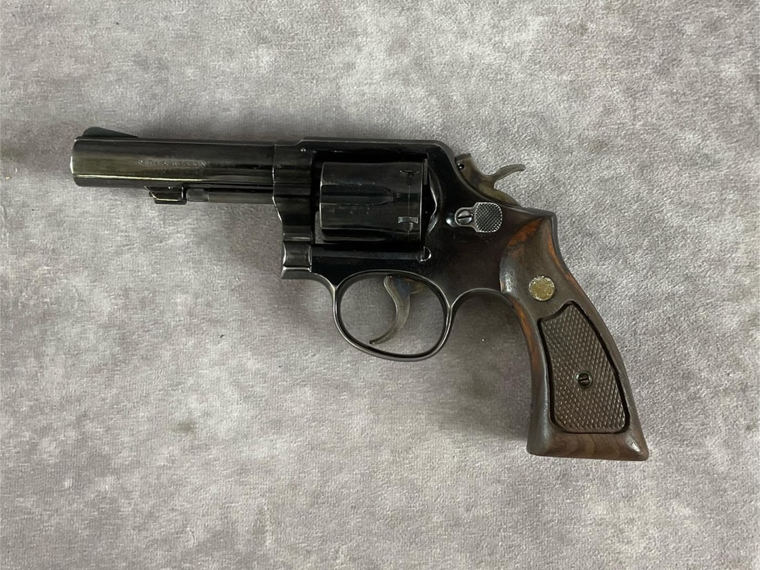 Smith & Wesson 38 Special Revolver: Serial # D591286 Model 10. Military & Police. Blue steel finish and traditional wood grips. Signs of normal wear, blueing warn on barrel, some scratching of grips. Has a clean bore and functions