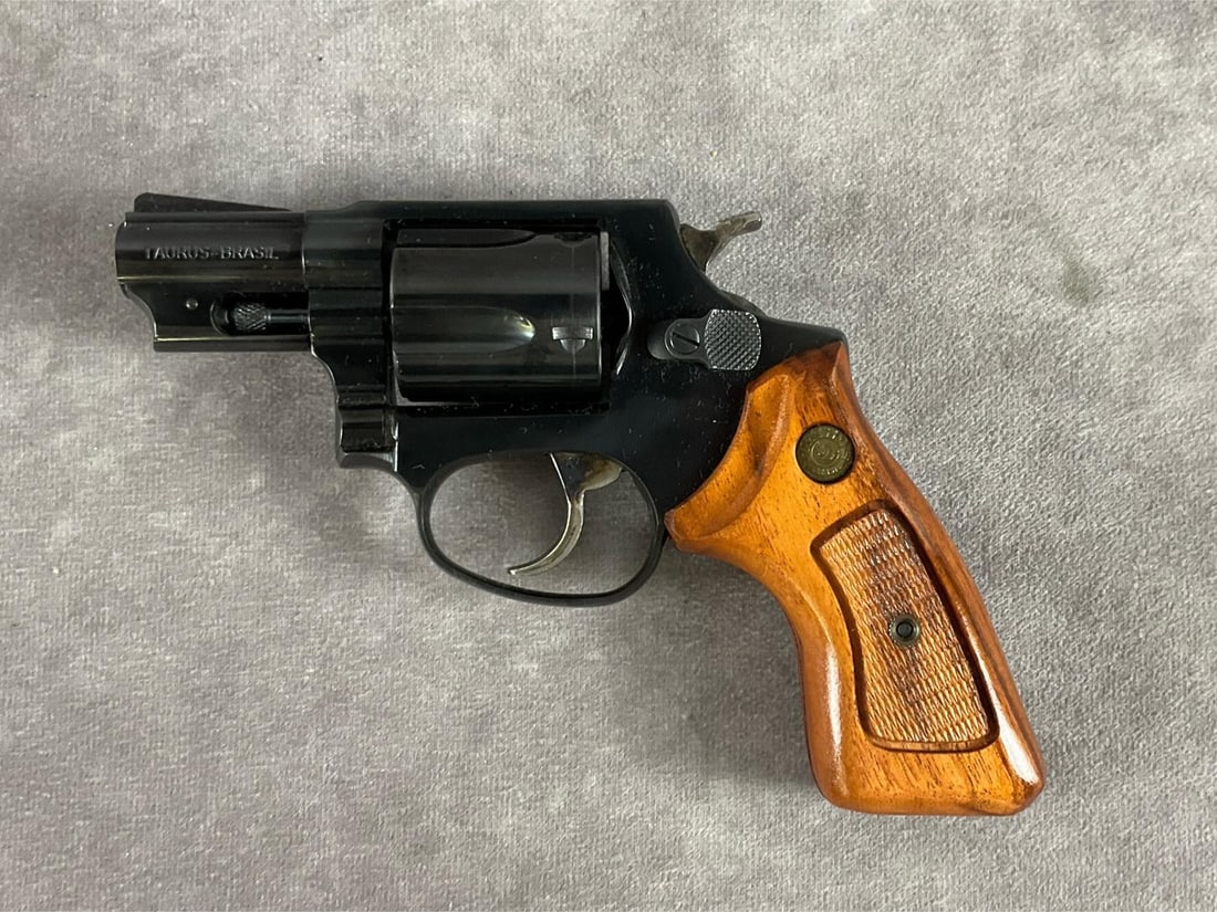 Taurus 38 Special Revolver: Serial # NB66816 38 special revolver. Original blue finish and wood grips. Clean bore and functions correctly. Overall in good condition, no worn areas in metal or wood. Has original box. Barrel